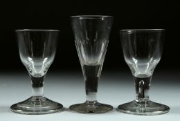 THREE SMALL PLAIN GEORGIAN GLASSES. 4.5ins, 4ins & 4ins, one with a tiny ship to the bowl.