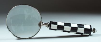 A MAGNIFYING GLASS with checkered handle.