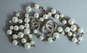 A CHANEL 43 PEARL NECKLACE with brilliant set double C clasp.