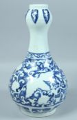 A CHINESE BLUE AND WHITE GARLIC HEAD VASE decorated with phoenix and clouds. 13ins high.