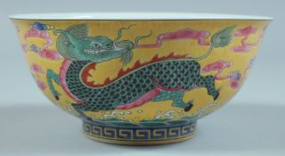 A CHINESE BOWL decorated with animals on a yellow ground. 5.75ins diameter.