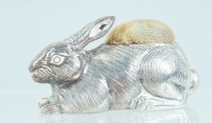 A CAST SILVER RABBIT PIN CUSHION. 2.25ins long.