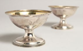 A PAIR OF GEORGE III SILVER CIRCULAR SALTS London 1972 3.75ins diameter.