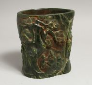 A CHINESE JADE BRUSH POT covered with figures and lotus. 6ins high.