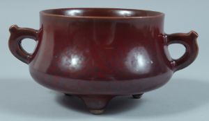 A CHINESE BRONZE GLAZED TWO HANDLED CENSER. 4ins diameter.