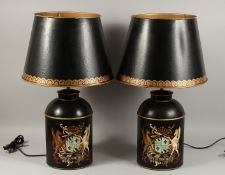 A PAIR OF BLACK TOLEWARE LAMPS AND SHADES.