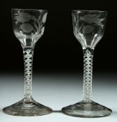 A PAIR OF GEORGIAN WINE GLASSES the bowls engraved with a bird, thistle and leaves, with white
