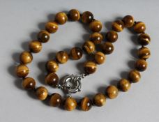 A TIGER'S EYE BEAD NECKLACE. 17ins long.