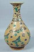 A LARGE CHINESE BROWN GLAZED VASE decorated with butterflies in relief. 14ins high.