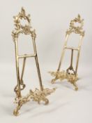 A LARGE PAIR OF BRASS EASELS. 21ins high.