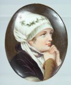 A PORCELAIN OVAL PLAQUE OF A YOUNG GIRL. 3ins x 2.5ins