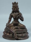 A CHINESE BRONZE BUDDHA on an oval base 7.5ins high.