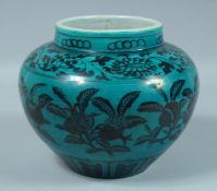 A CHINESE TURQUOISE GROUND BOWL decorated with dark blue lotus. 7.5ins diameter.