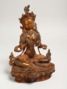 A CHINESE GILT BRONZE SEATED DEITY, with coral and turquoise. Signed. 9ins high.
