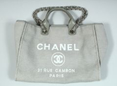 A GOOD CHANEL GREY FABRIC ADVERTISING BAG. 31 Rue Cambon, Paris, with chrome handles. 15ins wide,