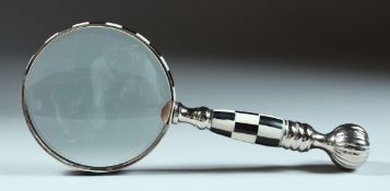 A MAGNIFYING GLASS with checkered handle.