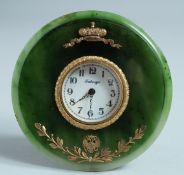 A SUPERB RUSSIAN SILVER GILT AND JADE CIRCULAR CLOCK on an easel support. 11cm diameter. Mark: R A.,