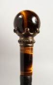 A TIGER'S EYE WALKING CANE. 33ins long.