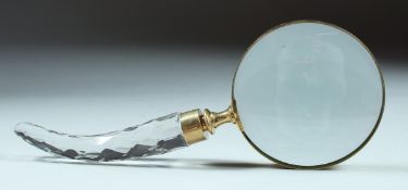 A MAGNIFYING GLASS with cut glass handle.