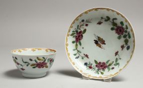 A CHAFFERS LIVERPOOL TEA BOWL AND SAUCER painted with Oriental style flowers in famille rose verte