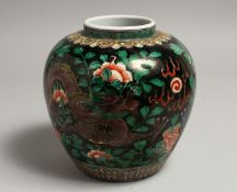 A CHINESE FAMILLE NOIR VASE painted with a dragon design. 6.5ins high.