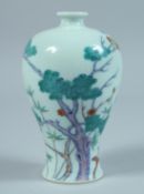 A SMALL CHINESE VASE decorated with trees. 5ins high.