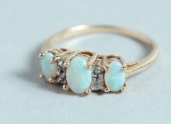 A THREE STONE OPAL AND DIAMOND RING.