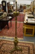 AN ORNATE BRASS FLOOR STANDING LAMP.