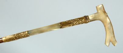 A GOOD EDWARDIAN ALLIGATOR WALKING STICK with gilt bands and mother of pearl handles. 36ins long.