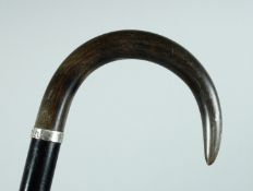 A VICTORIAN WALKING STICK with Rhino handle and two silver bands Birmingham 1886, 36ins long.