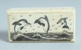 A BONE BOX with folding top with three dolphins 2.5ins long.