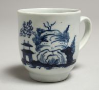 A CHAFFERS LIVERPOOL COFFEE CUP painted with a hut and large rock in under glaze blue. Provenance: