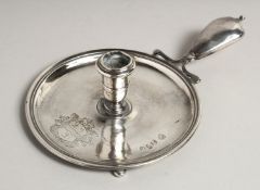 A RARE QUEEN ANNE SILVER CHAMBER CANDLESTICK, crest with three lions, handle engraved I. M. 5.5ins