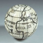 AN ETCHED BONE BALL SHAPED COMPASS. 2.5ins diameter.