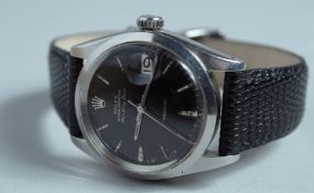 A ROLEX OYSTER PERPETUAL AIR - KING - DATE BLACK FACE WRISTWATCH with leather strap.