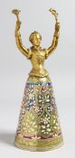 A GOOD VIENNA GILDED METAL AND GLASS WAGER CUP as a young lady with outstretched arms, the glass