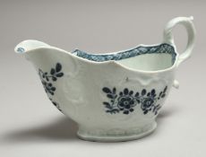 A JAMES PENNINGTON LIVERPOOL SAUCE BOAT well moulded and painted with blue under glaze flowers.