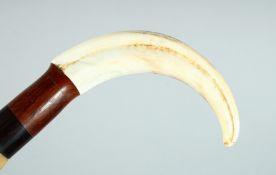 A GOOD WALKING STICK made of various specimen woods and bone handle. 35ins long.