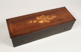 A 19TH CENTURY FRENCH ROSEWOOD CASED MUSICAL BOX, the top with musical trophies. 20ins long.