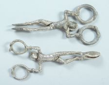 A PAIR OF VICTORIAN CAST SILVER HARLEQUIN SUGAR TONGS. London, 1858, maker, W M. and a plated