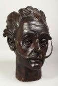 A BRONZE BUST OF SALVADOR DALI. 14ins high.