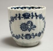 A JOHN PENNINGTON REEDED COFFEE CUP painted with flowers in underglaze blue.