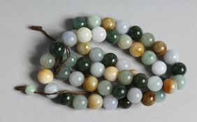A JADE AND NEPHRITE BEAD NECKLACE. 24ins long.