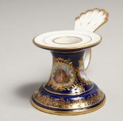 A SMALL 19TH CENTURY MEISSEN CANDLESTICK, blue ground edged in gilt with painted panels. Meissen