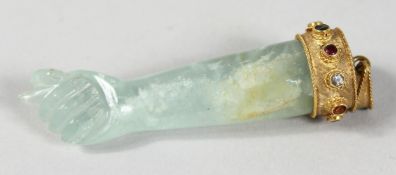 A ROCK CRYSTAL ARM AND HAND with gold mount. 3ins long.