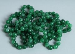 A STRING OF JADE BEADS.