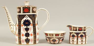 A ROYAL CROWN DERBY OLD IMARI PATTERN COFFEE POT SUGAR BOWL AND MILK JUG, NO. 1128 (3).