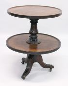 A GEORGIAN MAHOGANY CIRCULAR TWO TIER DUMB WAITER centre turned support, ending in tripod legs