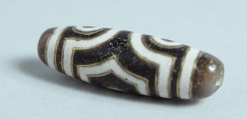 A GOLD INLAID AGATE ZUI BEAD.