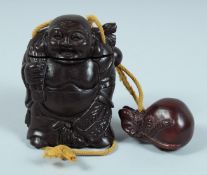 A JAPANESE CARVED WOOD BUDDHA INRO on a string. 8.5cm long.